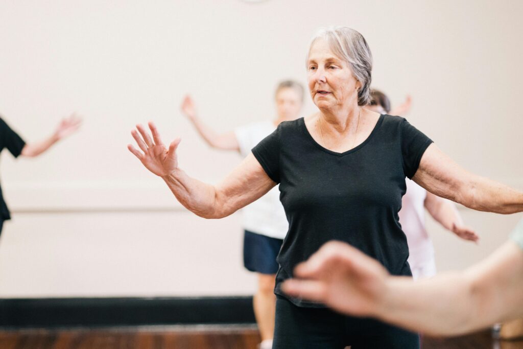 pexels-photo-12086690-12086690 Elderly women enjoying a fitness group exercise session indoors.