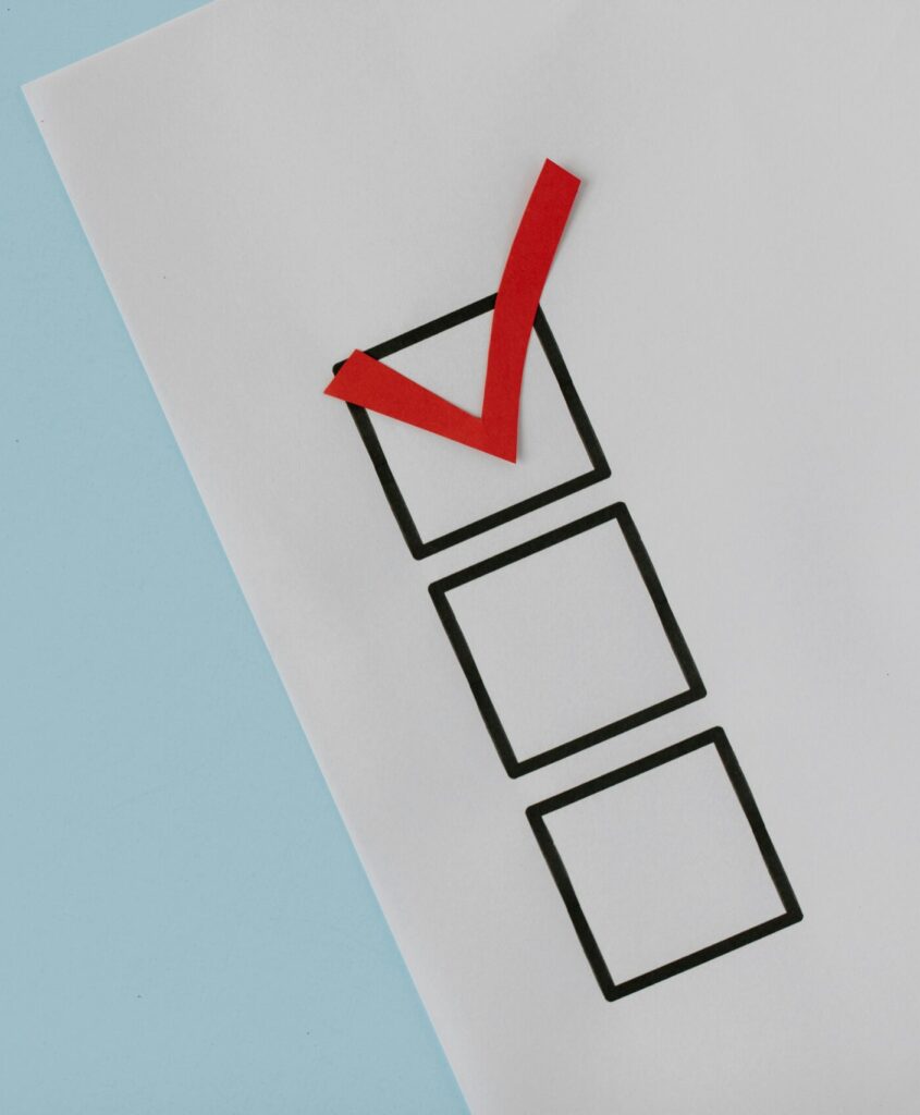 A simple white paper checklist with one red checkmark, ideal for concepts like completion or approval.